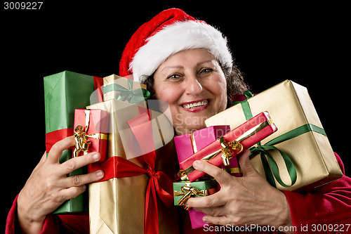 Image of Joyful Senior Woman Hugging Eight Wrapped Gifts
