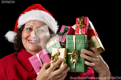 Image of Smiling Old Woman is Holding Seven Wrapped Gifts
