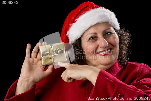 Image of Happy Old Woman with Red Cap Points at Xmas Gift
