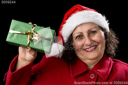 Image of Elderly Woman Holding up a Green Wrapped Xmas Gift
