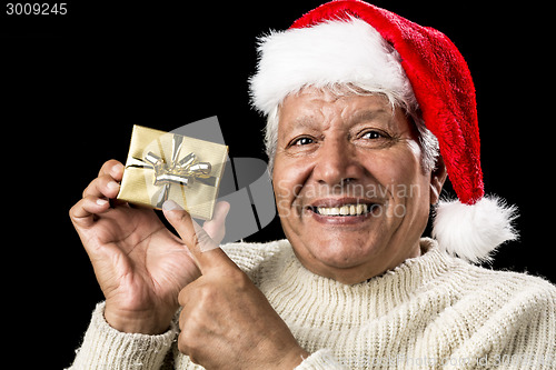 Image of Joyful Old Man Gesturing At Wrapped Golden Gift