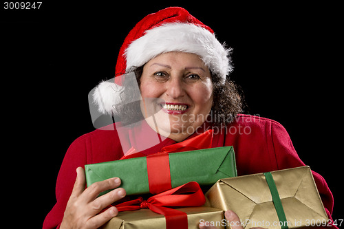 Image of Delighted Elderly Woman Hugging Three Wrapped Gifts
