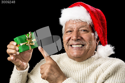 Image of Cheerful Old Man Pointing At Green Wrapped Gift