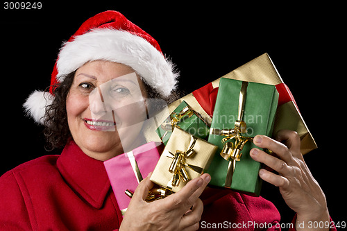 Image of Mature Lady Holding Up Five Christmas Presents
