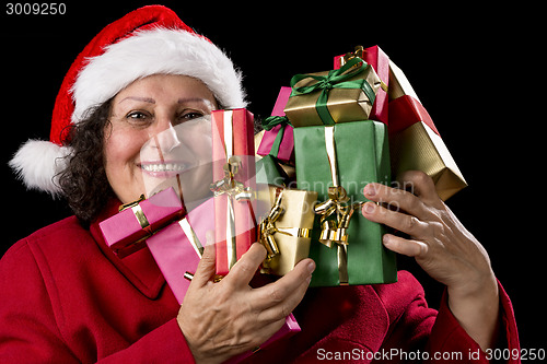 Image of Happy Female Senior Lifting Many Wrapped Presents
