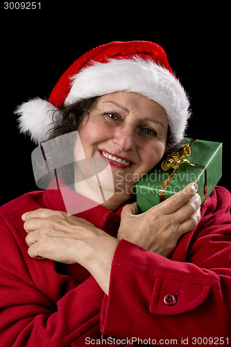 Image of Happy Aged Woman with Santa Cap and Wrapped Gift
