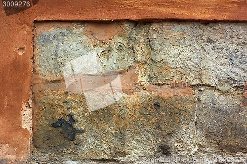 Image of Old stone wall with plaster shelled
