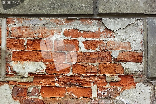 Image of Old brick wall with plaster shelled