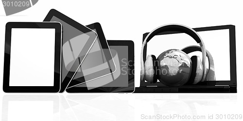 Image of headphones and  earth on the  laptop and tablet pc