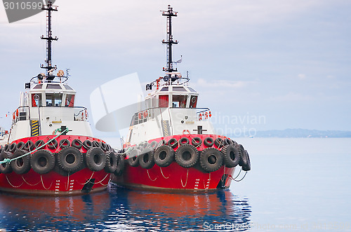 Image of red tugboats