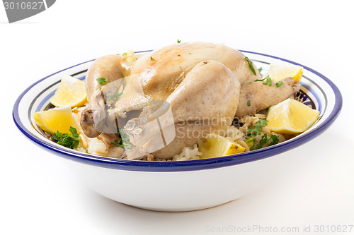 Image of Chicken on pilaf rice in a Tunisian serving bowl
