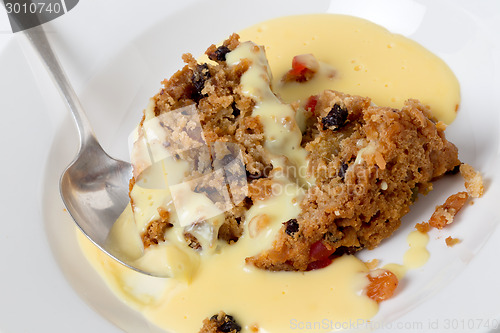 Image of college pudding and custard with a spoon