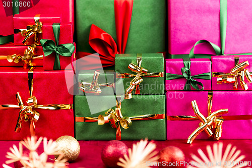 Image of Three Stacks of Xmas Presents Arranged by Color