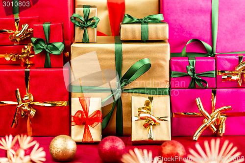 Image of Three Heaps of Christmas Gifts Sorted by Color