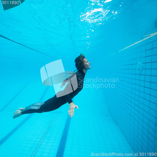 Image of Female diver flying underwater