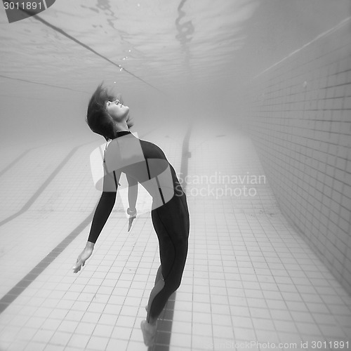 Image of Female diver suspended in space underwater