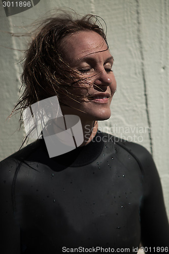 Image of Attractive smiling female swimmer with eyes closed