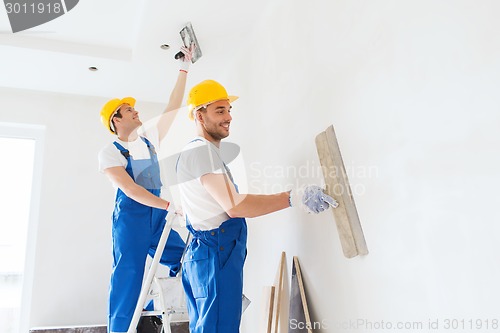 Image of group of builders with tools indoors