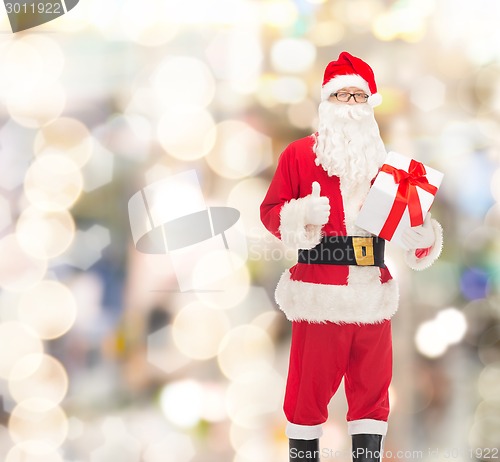 Image of man in costume of santa claus with gift box