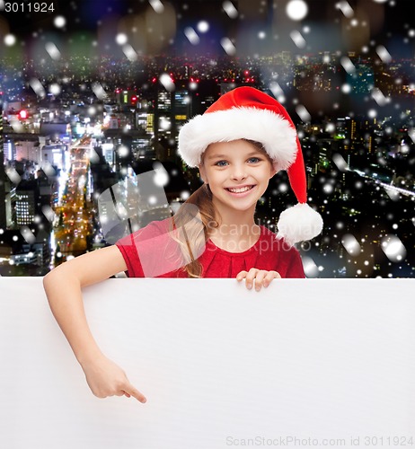 Image of girl in santa helper hat with blank white board