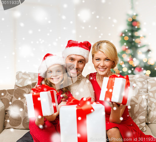 Image of smiling family holding many gift boxes