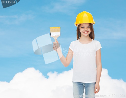 Image of smiling little girl in helmet with paint brush