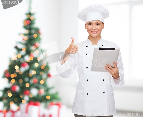 Image of smiling chef with tablet pc showing thumbs up