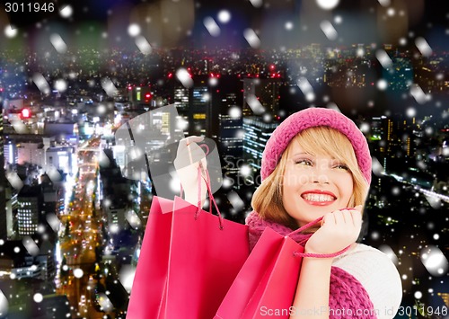 Image of smiling young woman with shopping bags