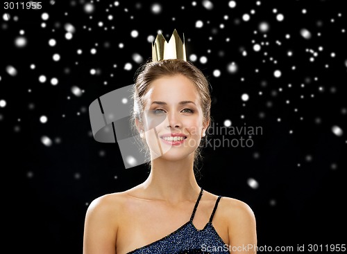 Image of smiling woman in evening dress wearing crown