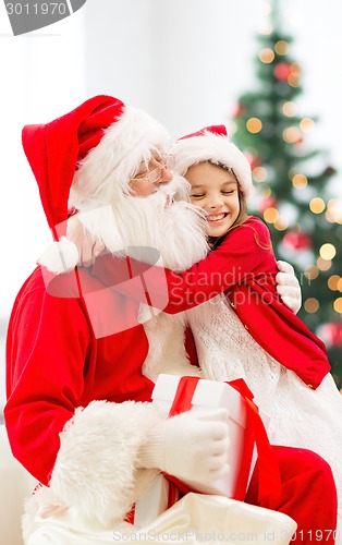 Image of smiling little girl with santa claus