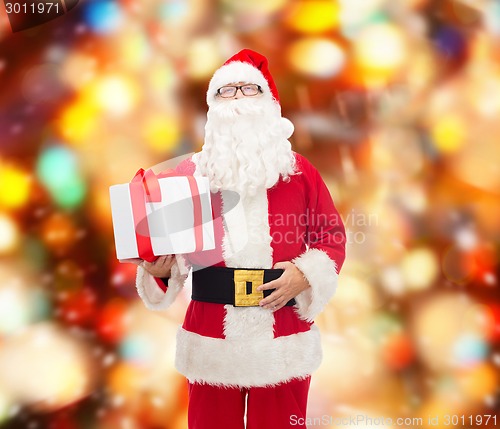 Image of man in costume of santa claus with gift box