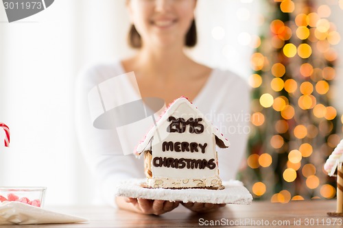 Image of close up of woman showing gingerbread house