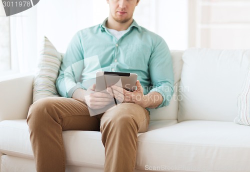Image of close up of man with tablet pc computer at home