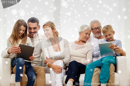 Image of smiling family with tablet pc computers at home