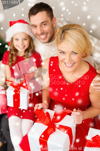 Image of smiling family holding many gift boxes