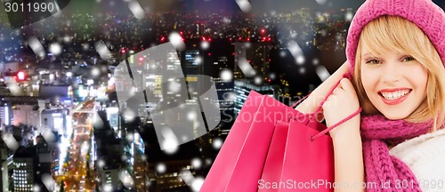 Image of smiling young woman with shopping bags