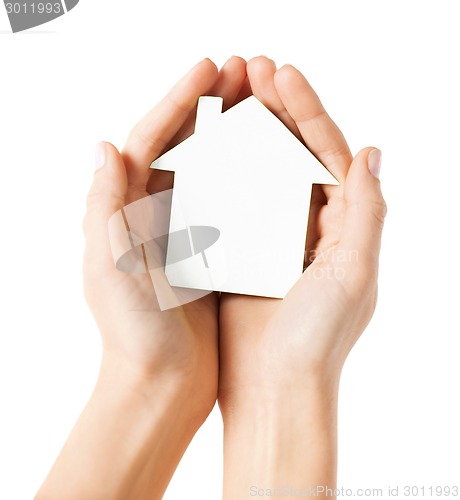 Image of hands holding white paper house