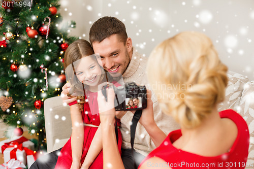 Image of happy family with digital camera taking photo