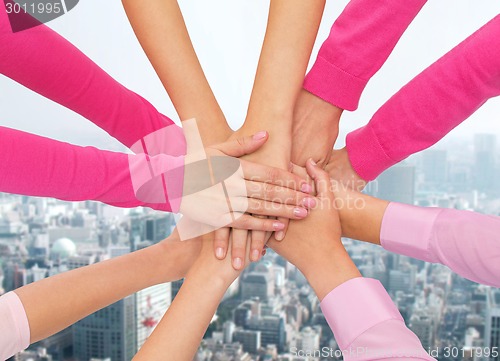 Image of close up of women with hands on top