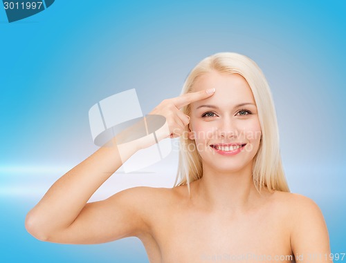 Image of beautiful woman touching her forehead