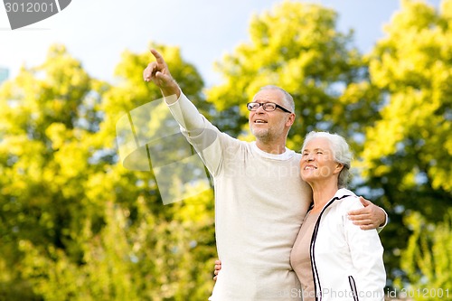 Image of senior couple hugging in park