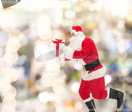 Image of man in costume of santa claus with gift box