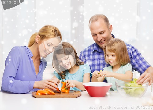 Image of happy family with two kids making dinner at home