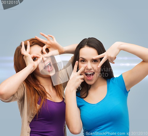 Image of smiling teenage girls having fun