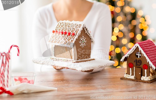 Image of close up of woman showing gingerbread house