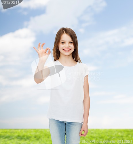 Image of smiling little girl in white blank t-shirt