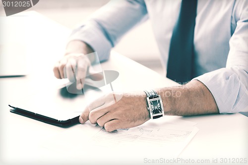 Image of businessman with tablet pc in office