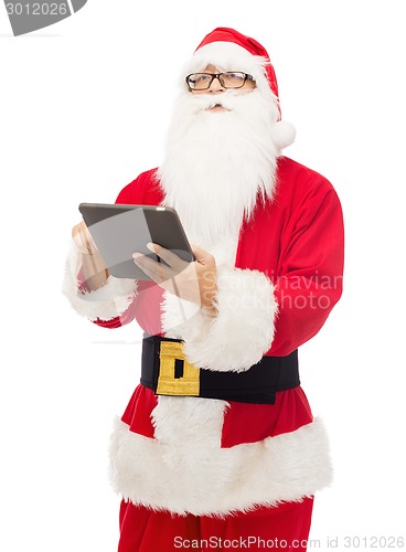 Image of man in costume of santa claus with tablet pc