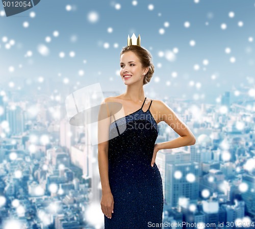 Image of smiling woman in evening dress wearing crown