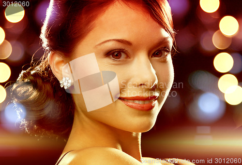 Image of woman in evening dress wearing diamond earrings